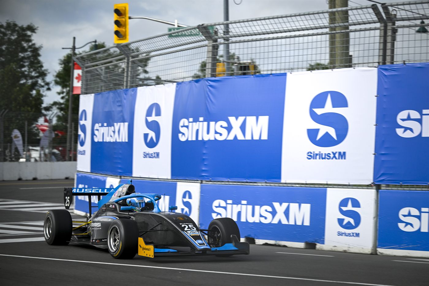 Musella's car on the concrete-lined Streets of Markham circuit.